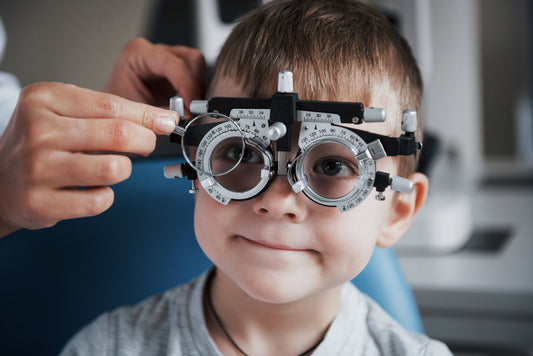 Young child having vision & prescription checked at eye test. Detect sight issues early, book your kid's eye examination today